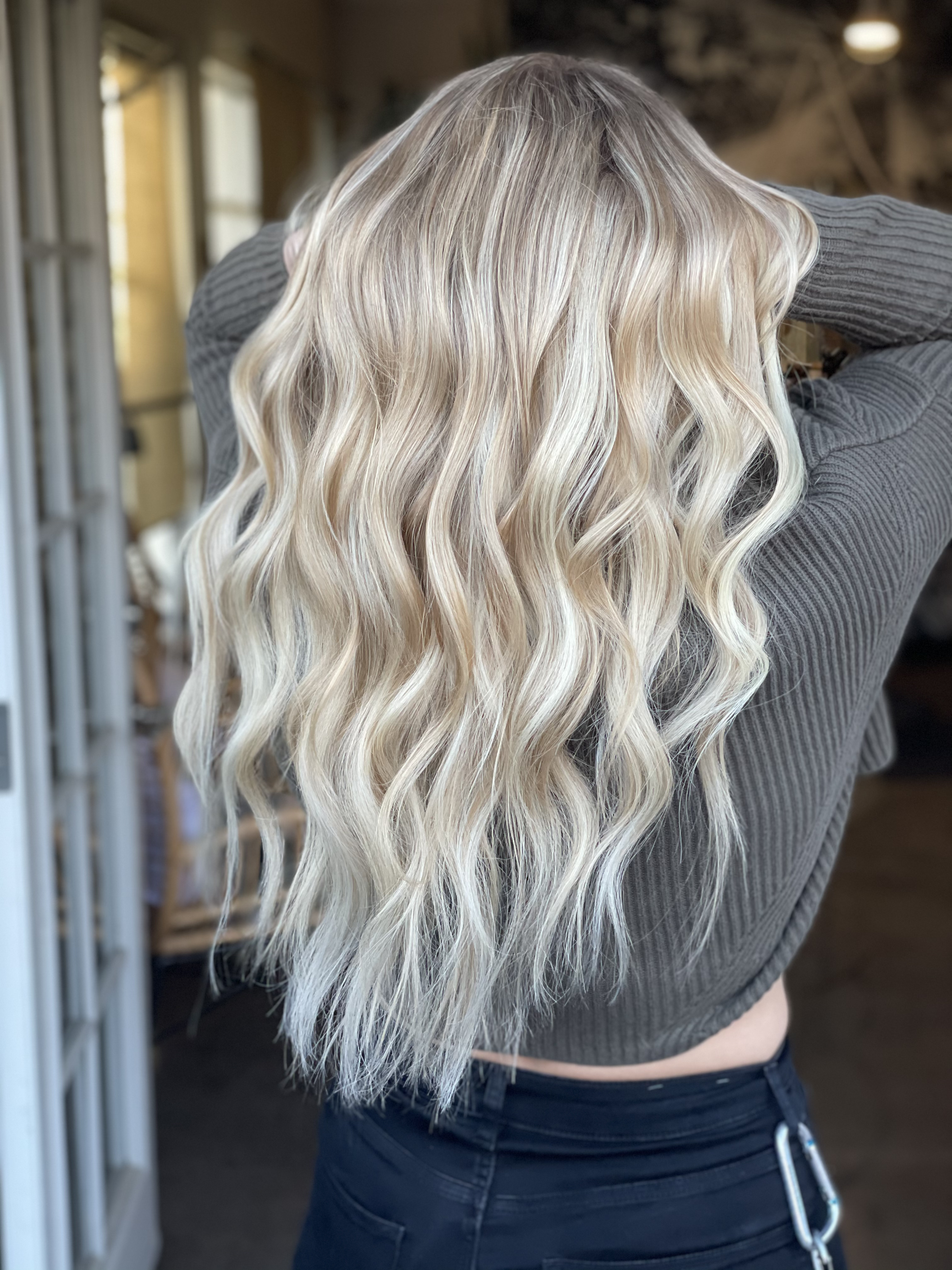 Should You Get Machine Weft, Flat Weft or Hand Tied Hair Extensions? image of blond room only showing back of her blond hair